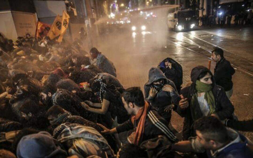 
Demonstrators in Istanbul tried to protect themselves from tear gas and water cannons used by Turkish riot police as they protested Tuesday against Turkey’s policy in Syria.
