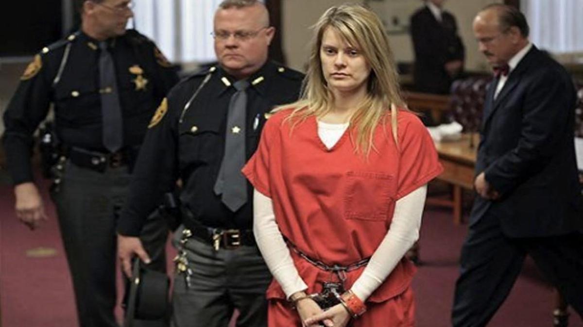Tara Lambert is escorted out of court in on Feb. 24, 2016, in Circleville, Ohio, after being sentenced to seven years in prison for attempting to hire a hit man to kill her husband’s ex. A federal appeals court judge overturned Lambert’s conviction his week.