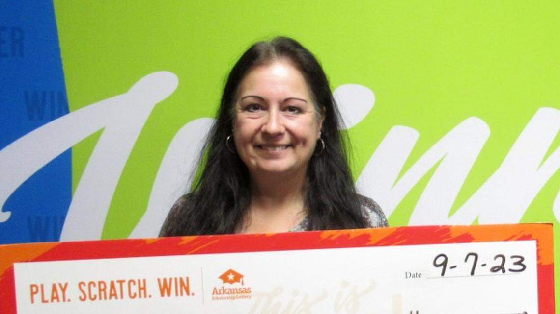 Paula Penn with her oversized check.