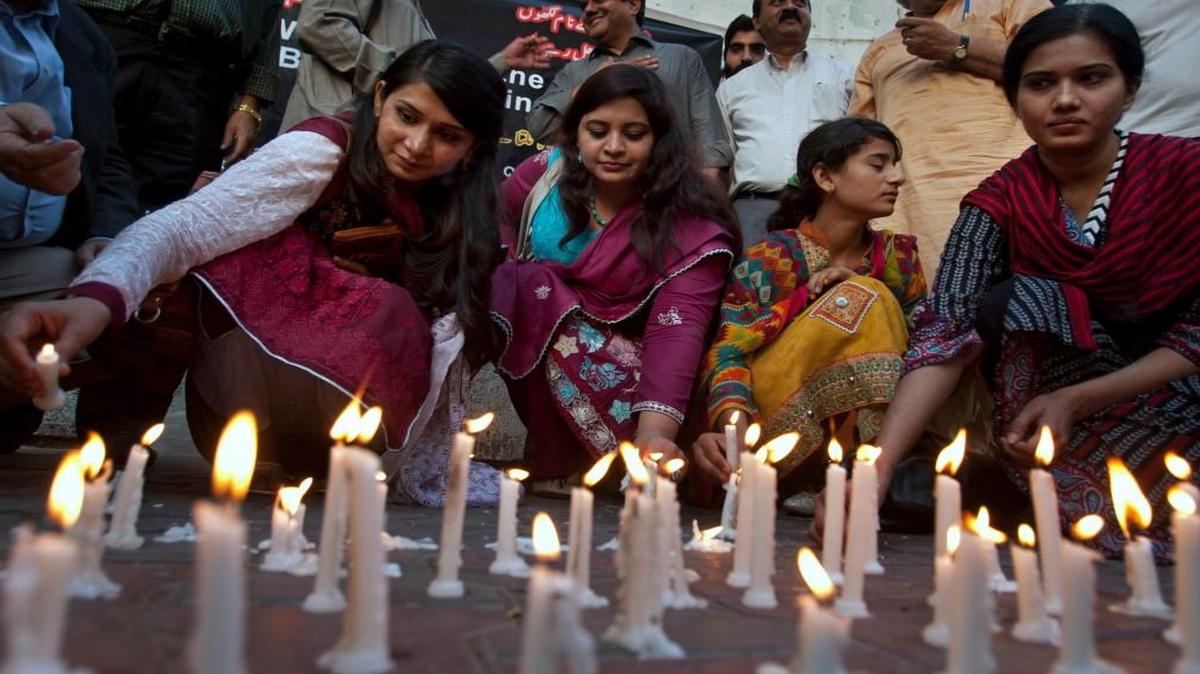 Members of a civil society group lit candles on Monday in Karachi, Pakistan, during a vigil for the victims of Sunday’s suicide bombing.