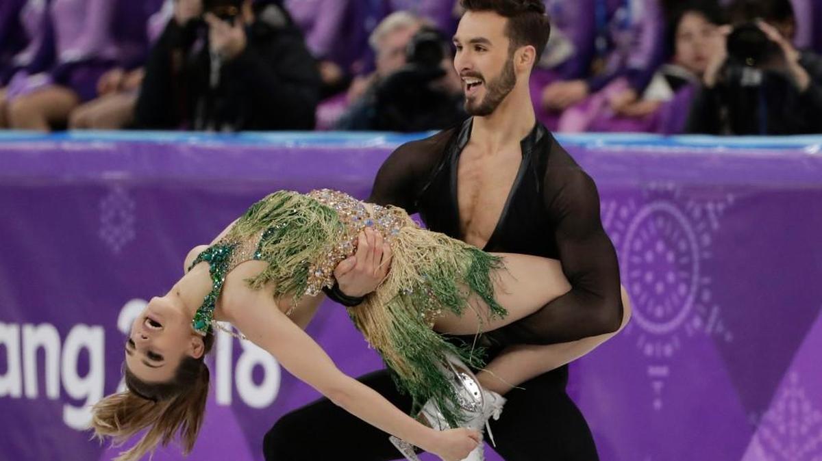 Gabriella Papadakis and Guillaume Cizeron of France kept skating, even though her halter dress came loose.