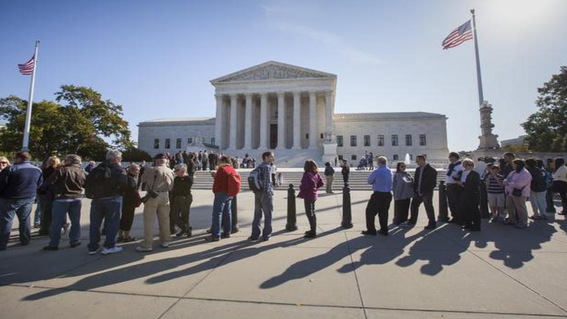 
People wait to enter the Supreme Court in Washington, Monday as it begins its new term. 
