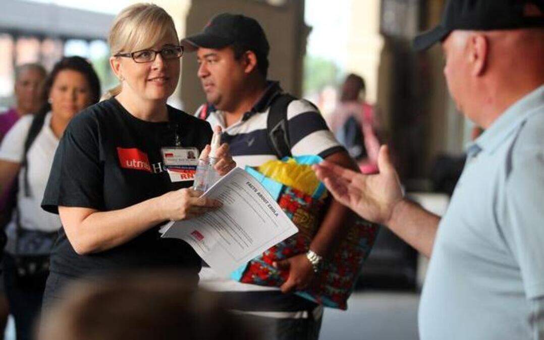 
As Carnival Magic passengers disembarked in Galveston, Texas, on Sunday registered nurse Christine Wade gave them Ebola fact sheets and answered questions. A Dallas health care worker was in voluntary isolation in her cabin aboard the cruise ship.
