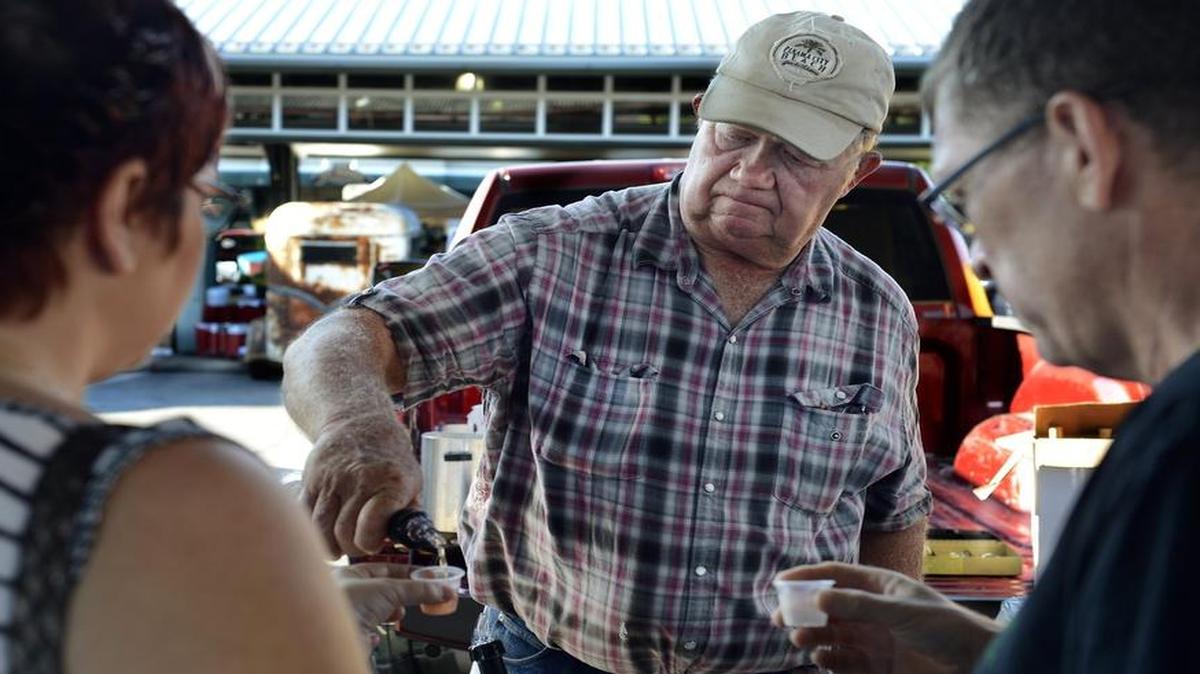 
Ron Fahrmeier of Fahrmeier Farms in Lexington, Mo., poured a wine sample at the City Market in 2014, the first year his family sold their wine there. Now the Kansas City Council will consider allowing sales of locally produced liquor and beer. 
