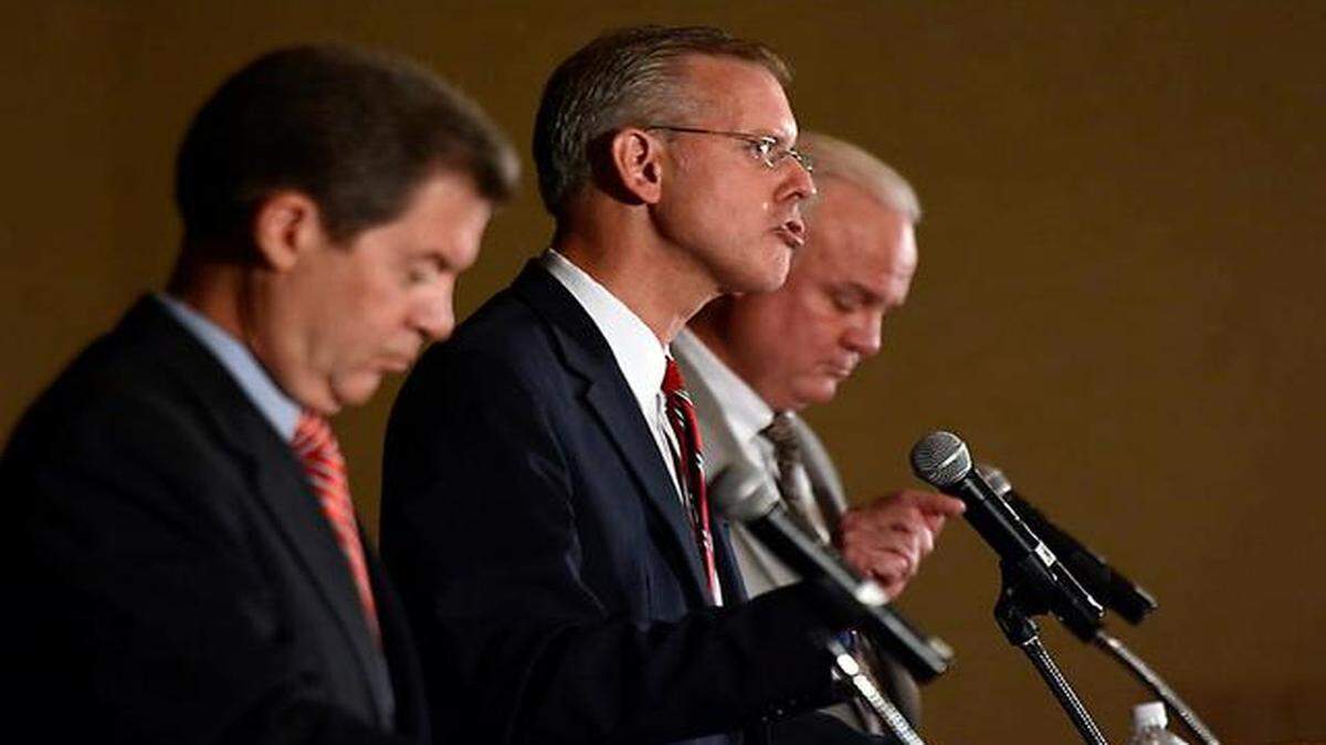 
Kansas Democratic gubernatorial candidate Paul Davis (center) spoke Friday while Republican Gov. Sam Brownback (left) and Libertarian candidate Keen Umbehr waited their turns. The debate in Overland Park was sponsored by the Johnson County Public Policy Council.

