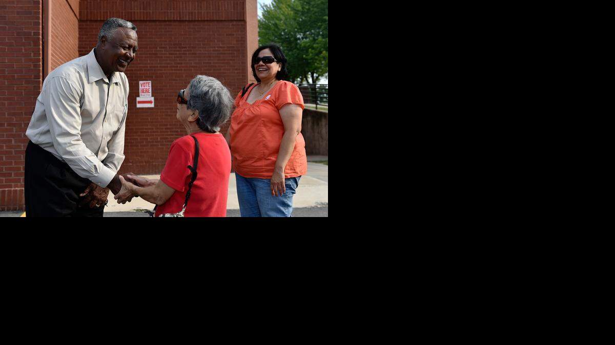 
Jackson County Legislature candidate Frank White greeted voters Tuesday evening, including Lucy Torres of Kansas City (center). She was accompanied by her daughter, also named Lucy Torres.
