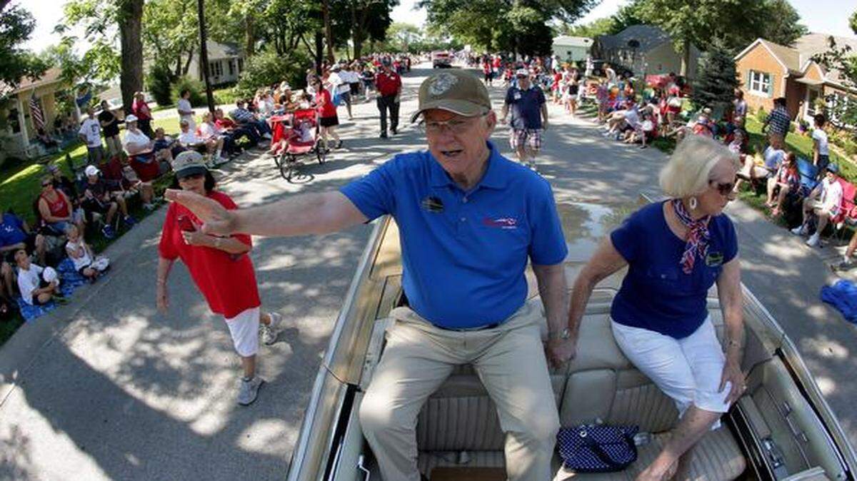 
Sen. Pat Roberts and his wife, Franki, wave to the crowd at a Fourth of July parade in Lenexa. Roberts is facing tea party-backed challenger Milton Wolf in the Republican primary.
