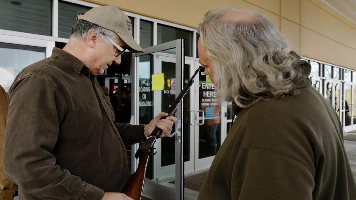 At Saturday’s Kansas City Gun Show at the KCI Expo Center in Kansas City, North, John Gooden of Odessa (left) and his brother Warren Gooden of Cross Timbers, Mo., looked at the .22-caliber Winchester Model 62A that John purchased at the show. Both are collectors. John Gooden said he got this model because it was the kind he hunted with when growing up.