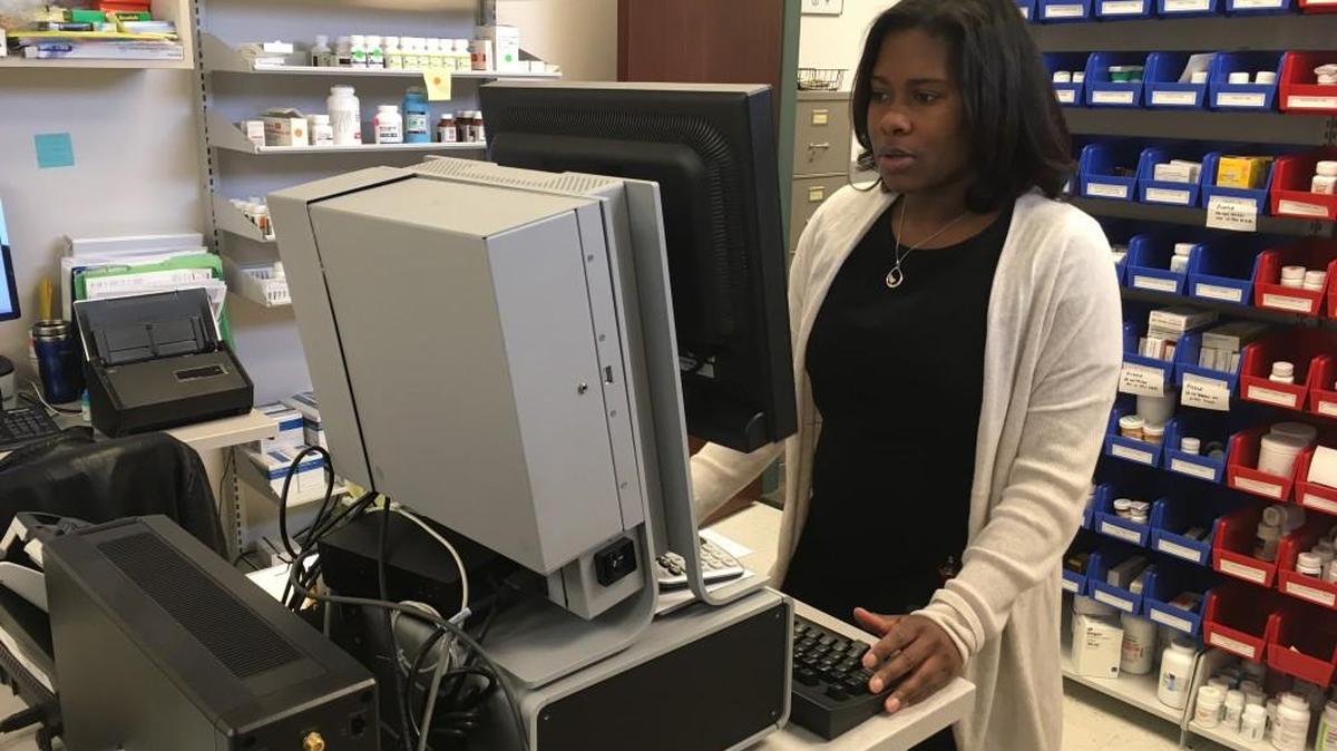 Kamile Johnson, the director of pharmacy at the KC Care Clinic, works on filling patient prescriptions Tuesday. Johnson said state laws restricting Medicaid drug coverage could harm patients.
