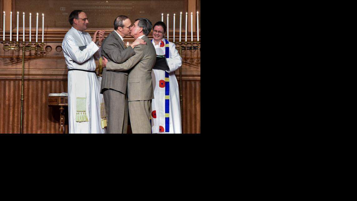 
Geraldo Sousa (left) kissed David Bergeron after they were married by the Revs. Peter Luckey and Eleanor McCormick at the Plymouth Congregational Church in Lawrence on Monday.

