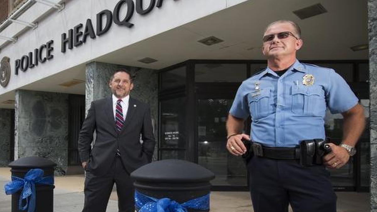 Longtime residents but still fairly fresh in their leadership roles, Kansas City, Kan., Mayor Mark Holland (left) and Police Chief Terry Zeigler are helping their community deal with this summer’s violence. The blue ribbons adorning the poles outside the city’s Police Headquarters were in support of the police.