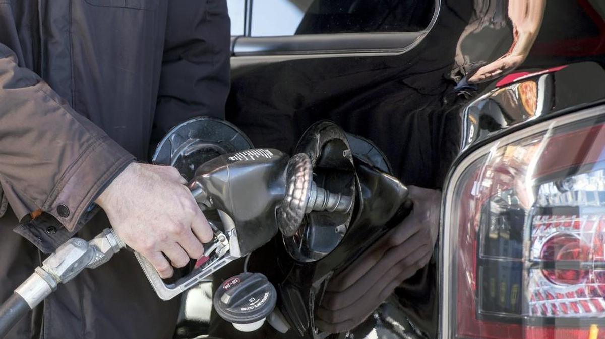 A man pumps gas at a Quik Trip in Kansas City. .
