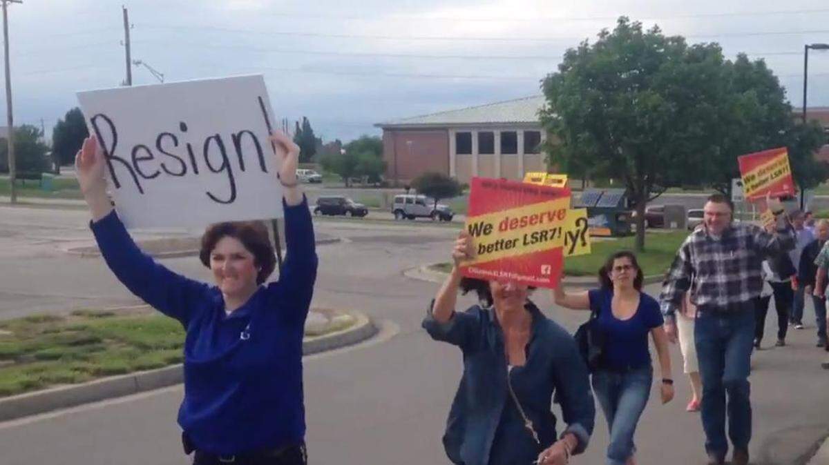 Lee's Summit citizens group at Thursday night's school board meeting, calling for the board president and superintendent to resign.