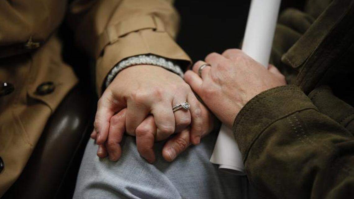 
The arguments for and against same-sex marriage have changed as the issue gains attention nationwide. Topeka residents Tessy Best and Quinta Avance held hands while waiting for their marriage application to be processed Thursday at the Douglas County Courthouse in Lawrence. 

