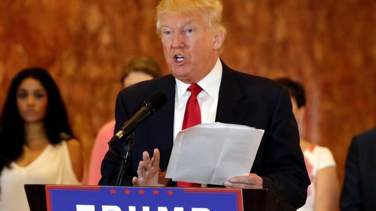 Republican presidential candidate Donald Trump reads from a list of donations to veteran’s groups during a news conference in New York Tuesday