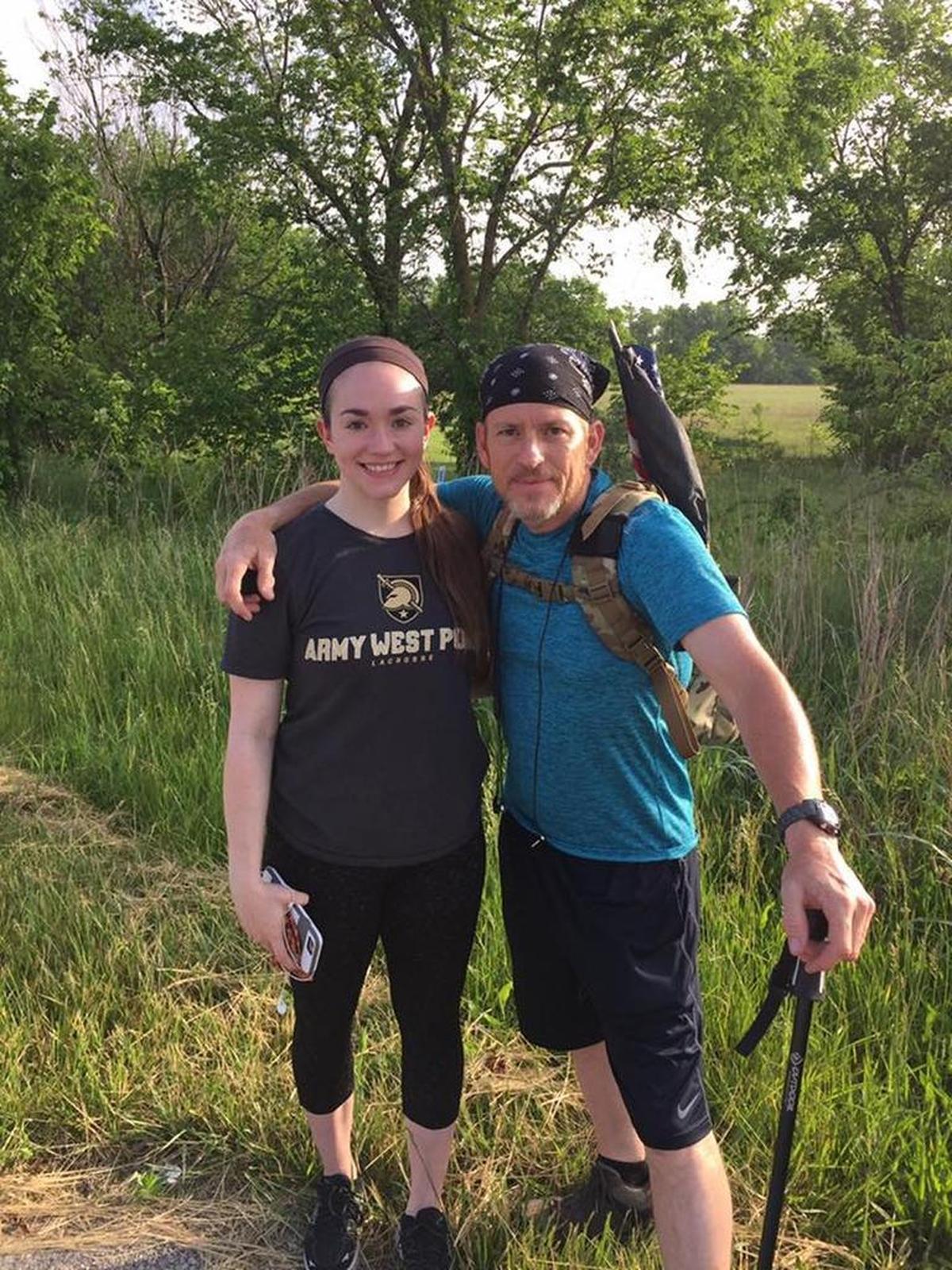 Kelly Sapp (right) is joined on his walk by daughter Malia (left) and wife Denise Sapp, who are following by vehicle.