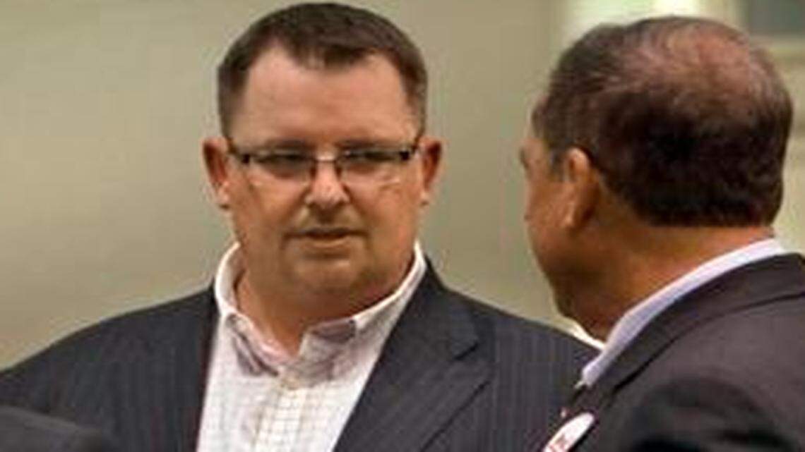 
Political consultants Steve Glorioso (left) and Jeff Roe (second from right) talk with supporters of a failed tax hike measure last year. 
