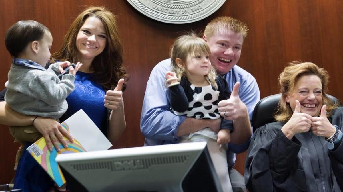 Johnson County District Court Judge Kathleen Sloan shared the joy as Brittany (left) and Matthew Branson adopted Mark Branson and his sister, Angelina Branson.