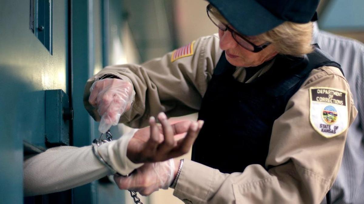 At the Ellsworth Correctional Facility in Ellsworth, Kan., a inmate was handcuffed recently before being transported from a segregation unit. Low wages among Kansas corrections officers are causing many to leave the field.