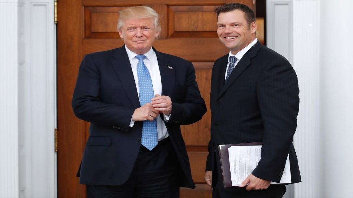 In this Nov. 20, 2016, file photo, Kansas Secretary of State Kris Kobach, right, holds a stack of papers as he meets with then President-elect Donald Trump in Bedminster, N.J. Kobach who is vice chairman of President Donald Trump's commission on election fraud drafted a proposal for Trump to change federal voter registration laws.