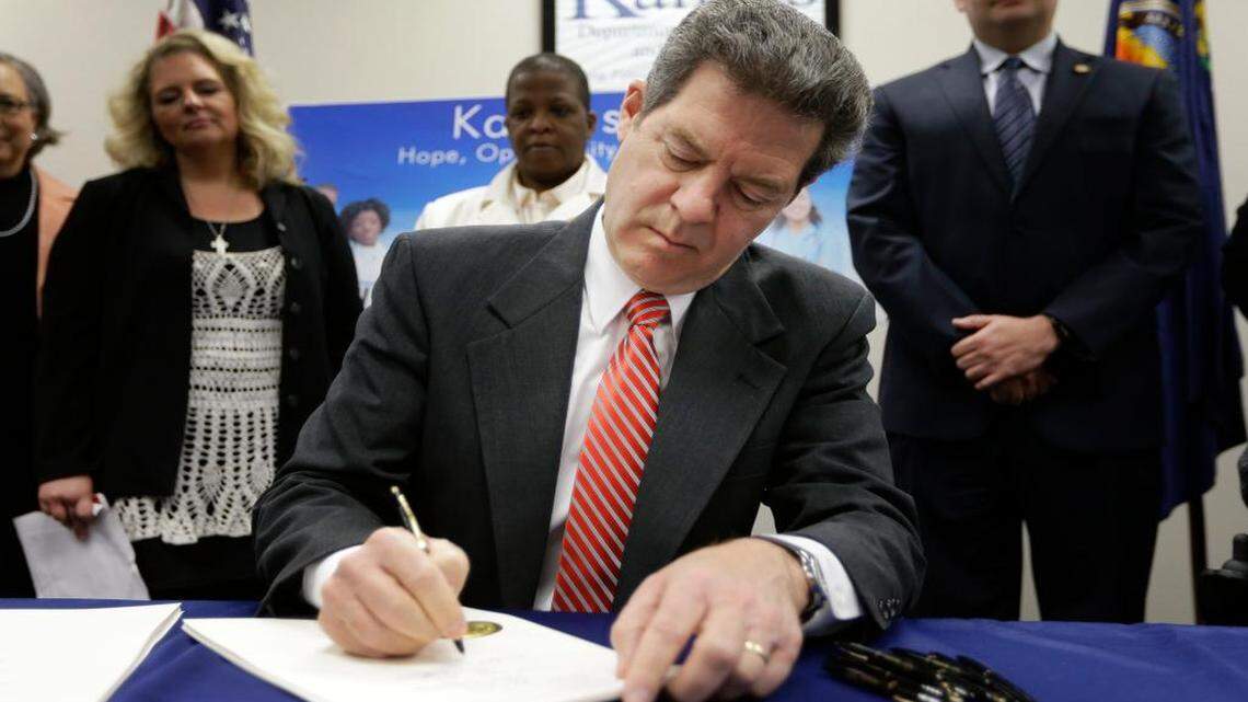 
Gov. Sam Brownback signed a welfare reform bill into law Thursday in Topeka. The law reduces the time a person can receive benefits and bans certain types of spending.
