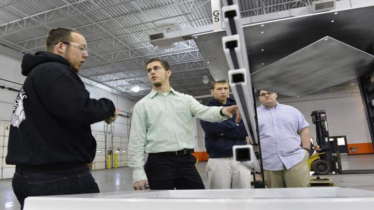 
Students from six Northland school districts are participating in the Center for Advanced Professional Studies, or CAPS. In this January 2014 file photo, Smithville High senior Justin Sweeny (from left), Park Hill South senior Scott Cline and Smithville High seniors Spencer Norton and Winston Wright discussed modifications for a rack at Holland 1916 Manufacturing in Liberty.
