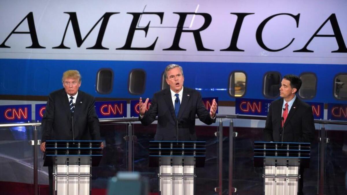 
Republican presidential candidate Jeb Bush (center) spoke Wednesday as Donald Trump (left) and Scott Walker looked on during the CNN Republican presidential debate.
