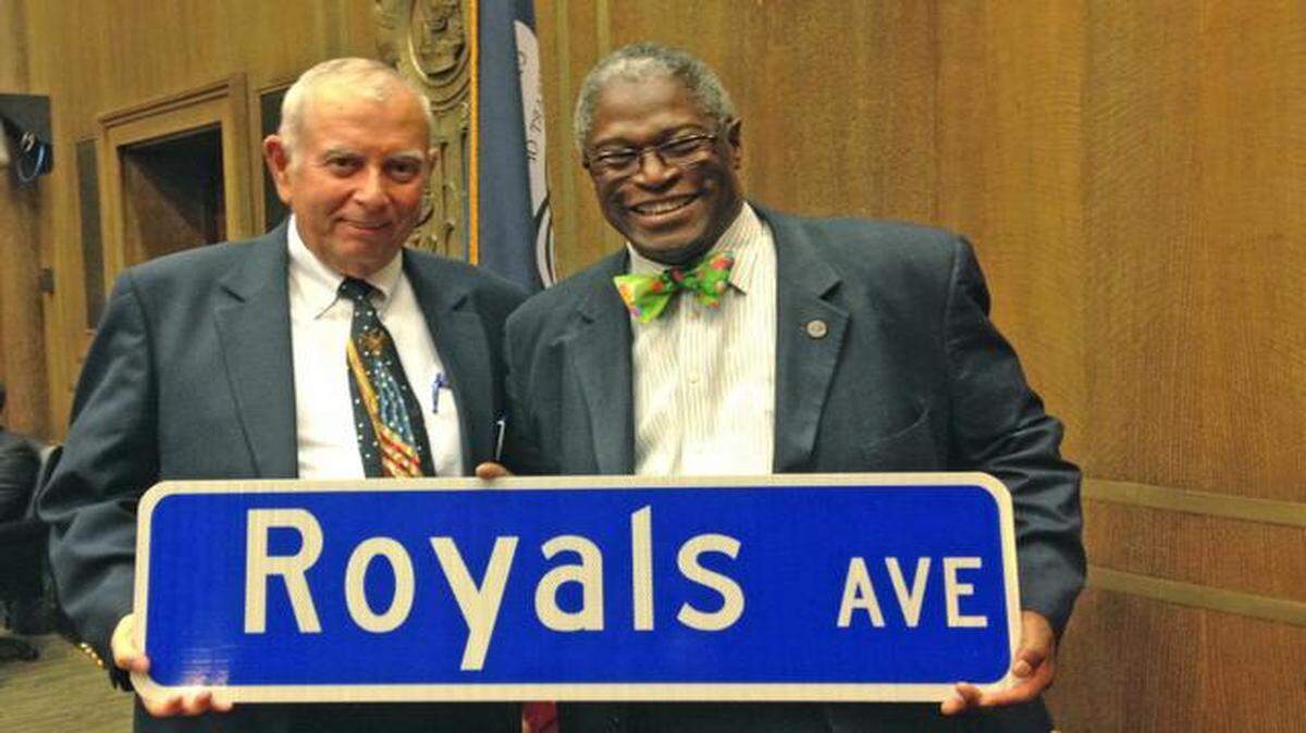 
City Councilman Dick Davis (left) and Mayor Sly James (right) show the symbolic street sign.
