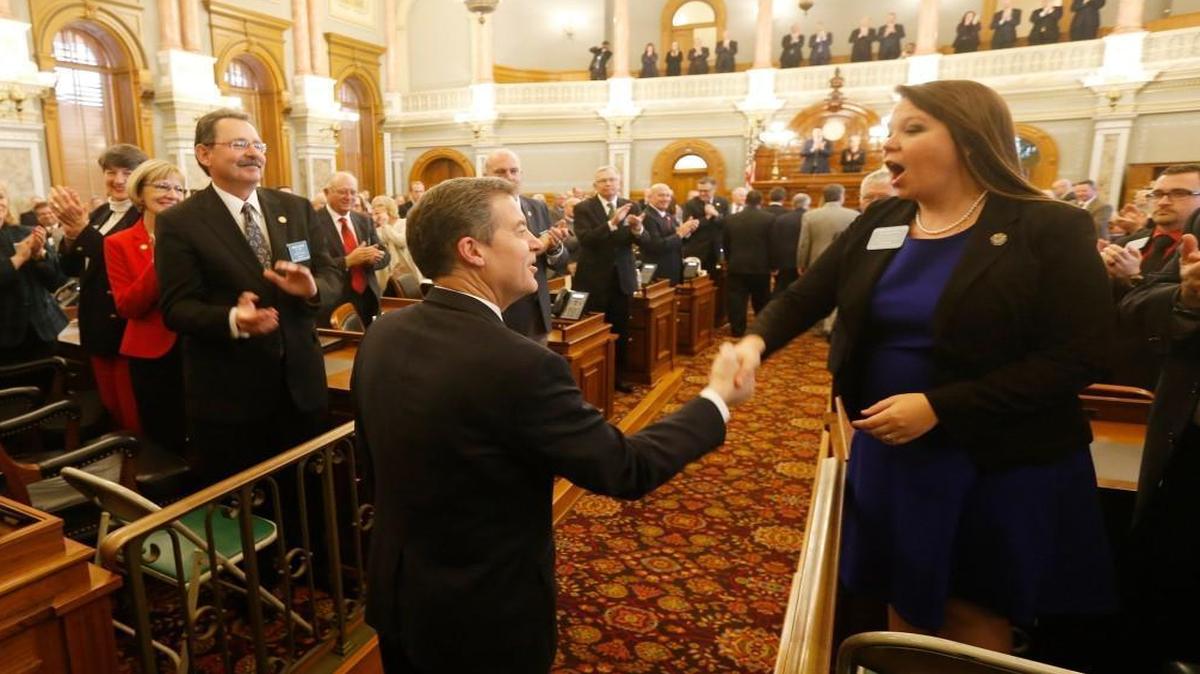Kansas Gov. Sam Brownback shook hands with Rep. Stephanie Clayton of Overland Park as he entered the House chambers on Tuesday for his State of the State speech. A day later, the governor unveiled his budget proposal.