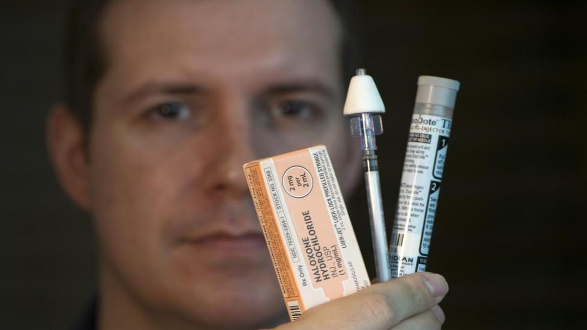 Johnson County EMS medical director Ryan Jacobsen shows examples of devices that could be used to administer the drug naloxone. This week, the Kansas Legislature passed a bill to allow the drug naloxone — which saves lives by stopping opioid overdoses — to be distributed similarly to an EpiPen to family members and patients who are prescribed opioids for pain management.