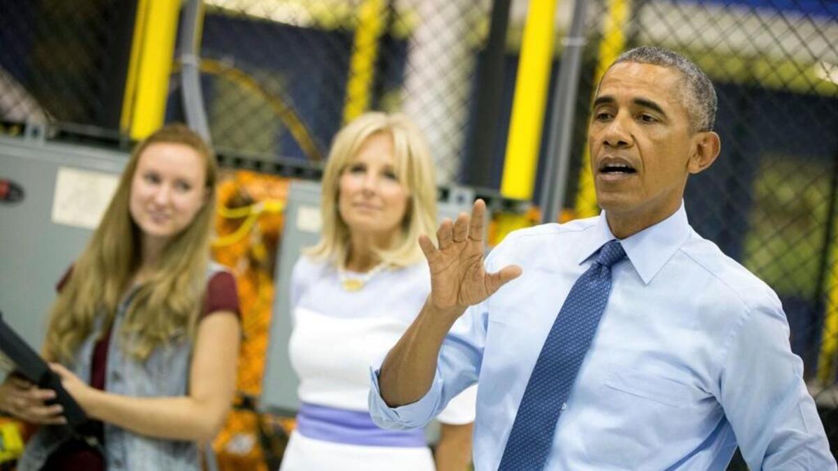 
President Barack Obama, accompanied by Jill Biden, second from right, tours Michigan Technical Education Center at Macomb Community College, Wednesday in Warren, Mich.
