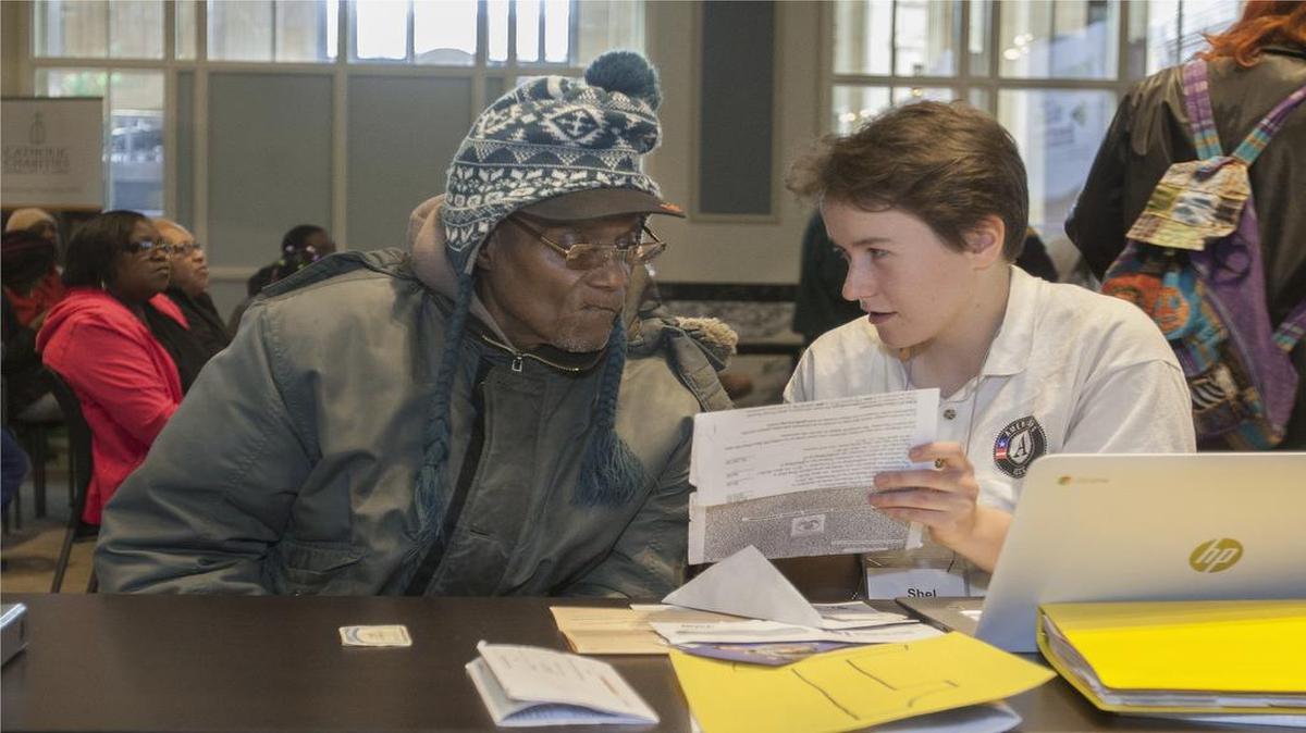 James Carter (left) of Kansas City got free help with his taxes from Americorps volunteer Michelle Reinertson on Saturday during Community Tax Day at Union Station.