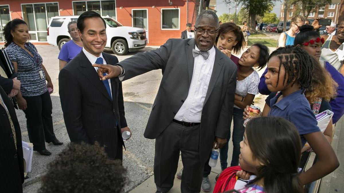
U.S. Department of Housing and Urban Development Secretary Julian Castro (left) and Mayor Sly James talked with youngsters at the Chouteau Courts housing project after their announcement on Monday.


