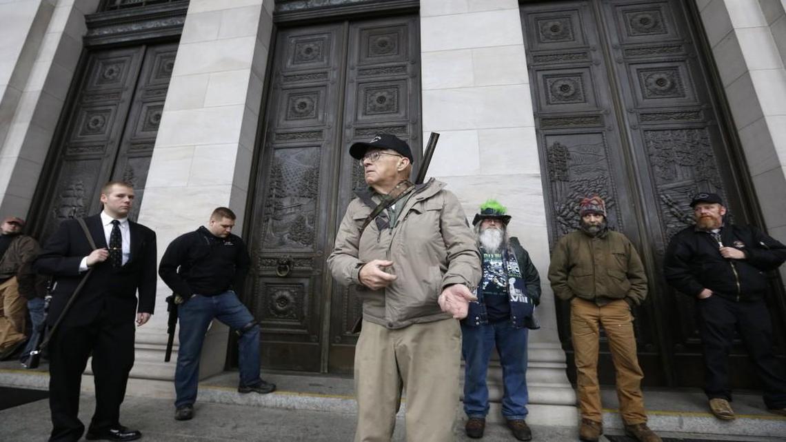 Mike Vanderboegh, of Pinson, Ala., mimicked holding a rifle as he spoke under a Capitol portico during a rally by gun-rights advocates in 2015 in Olympia, Wash.