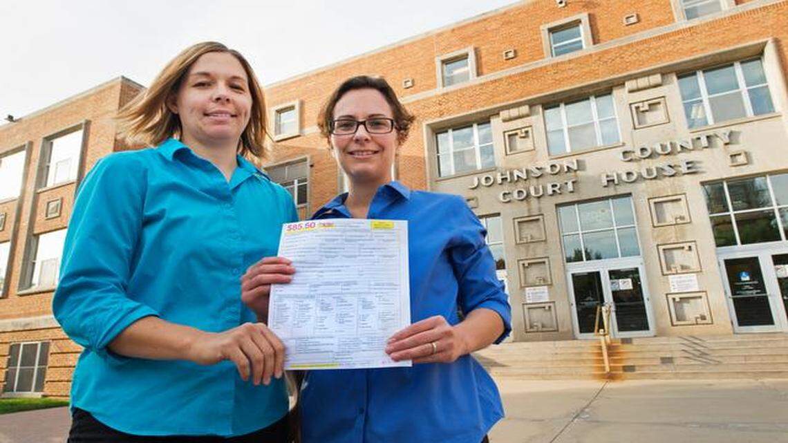 
Angela Schaefer (left), 31, and partner Jennifer Schaefer, 28, rushed to get an application for a marriage license Wednesday in Olathe. 
