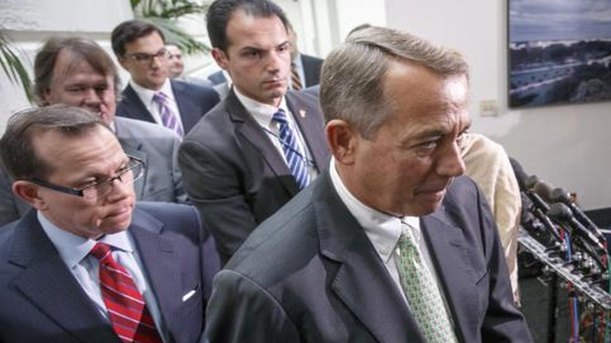 
Speaker of the House John Boehner of Ohio, walks past reporters following a closed-door meeting of House Republicans on Capitol Hill in Washington, Friday

