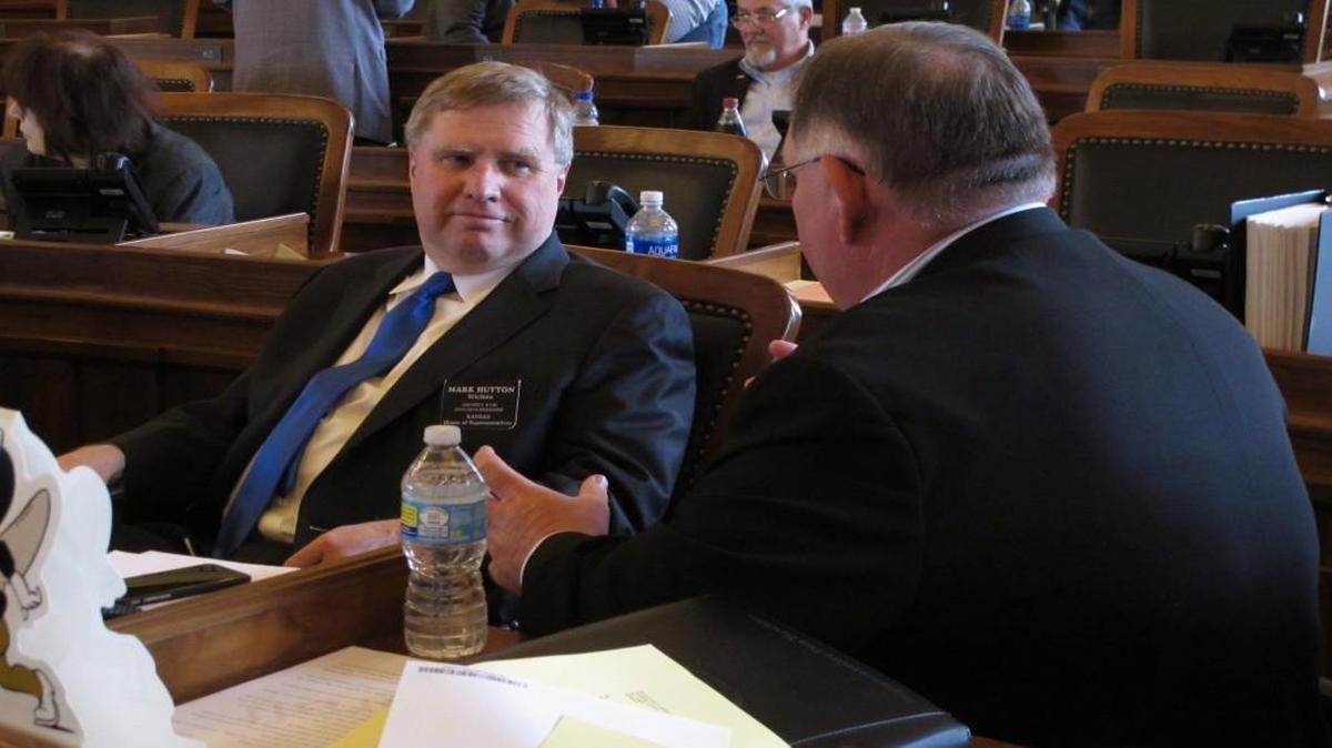 Kansas Rep. Mark Hutton (left), a Wichita Republican, conferred with Rep. Dan Hawkins, a Wichita Republican as the House met Sunday in Topeka to consider a plan to balance the state budget and close the legislative session