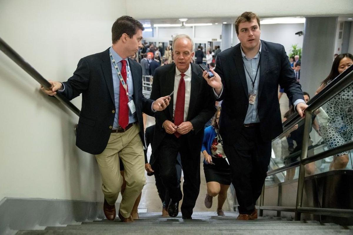U.S. Sen. Jerry Moran, a Kansas Republican, is pursued by reporters as he arrives on Capitol Hill in Washington, Tuesday, July 18, 2017.