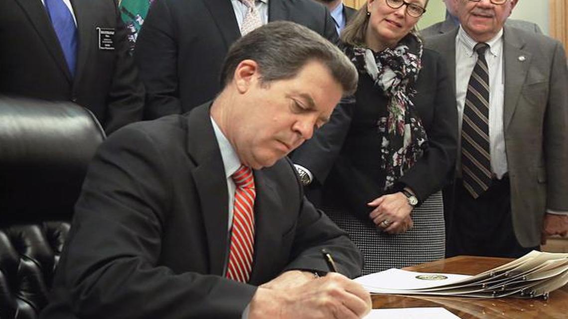 
Gov. Sam Brownback signed bipartisan legislation Thursday adding Kansas to the short list of states allowing unlicensed possession of concealed firearms and eliminating a weapons training mandate for people to carry hidden guns. He held a press conference later in the day that touched heavily on taxes and the state’s budget problems.
