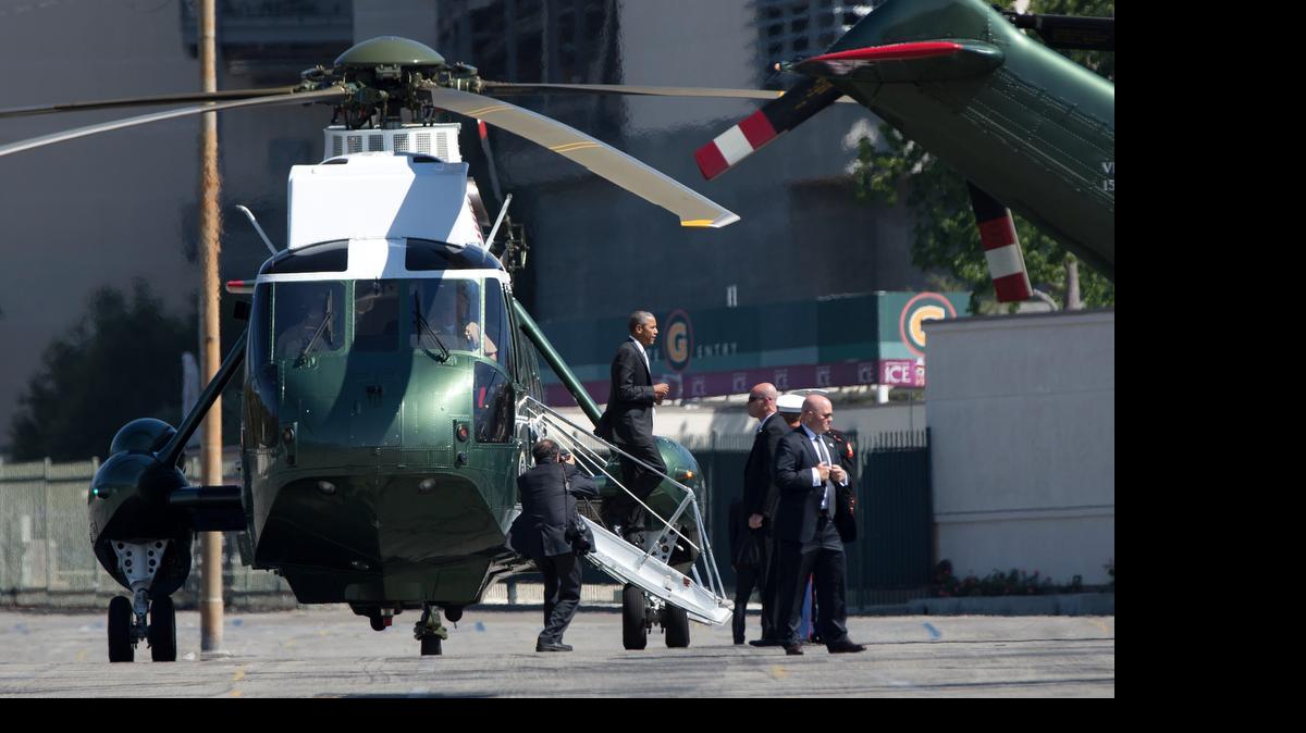 
President Barack Obama steps from Marine One in Pasadena, Calif., en route to tape a podcast interview with comedian Marc Maron. 
