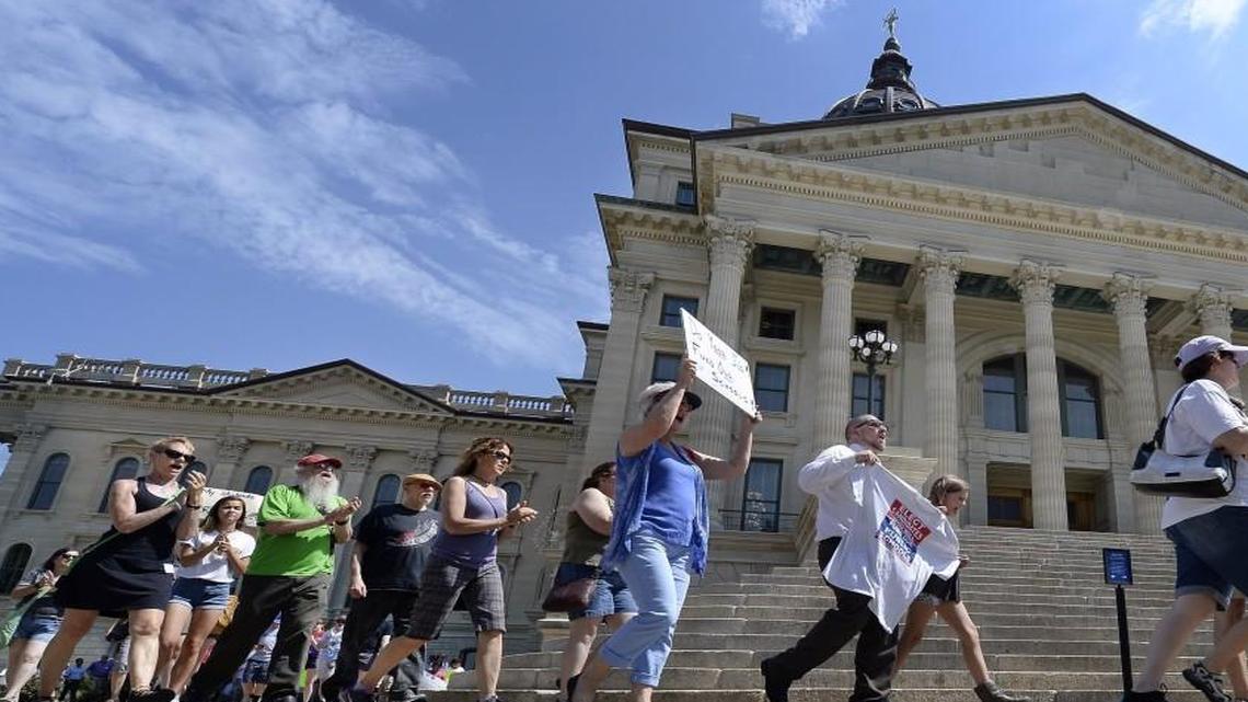 People calling for adequate and equitable funding for Kansas schools marched around the statehouse in June.