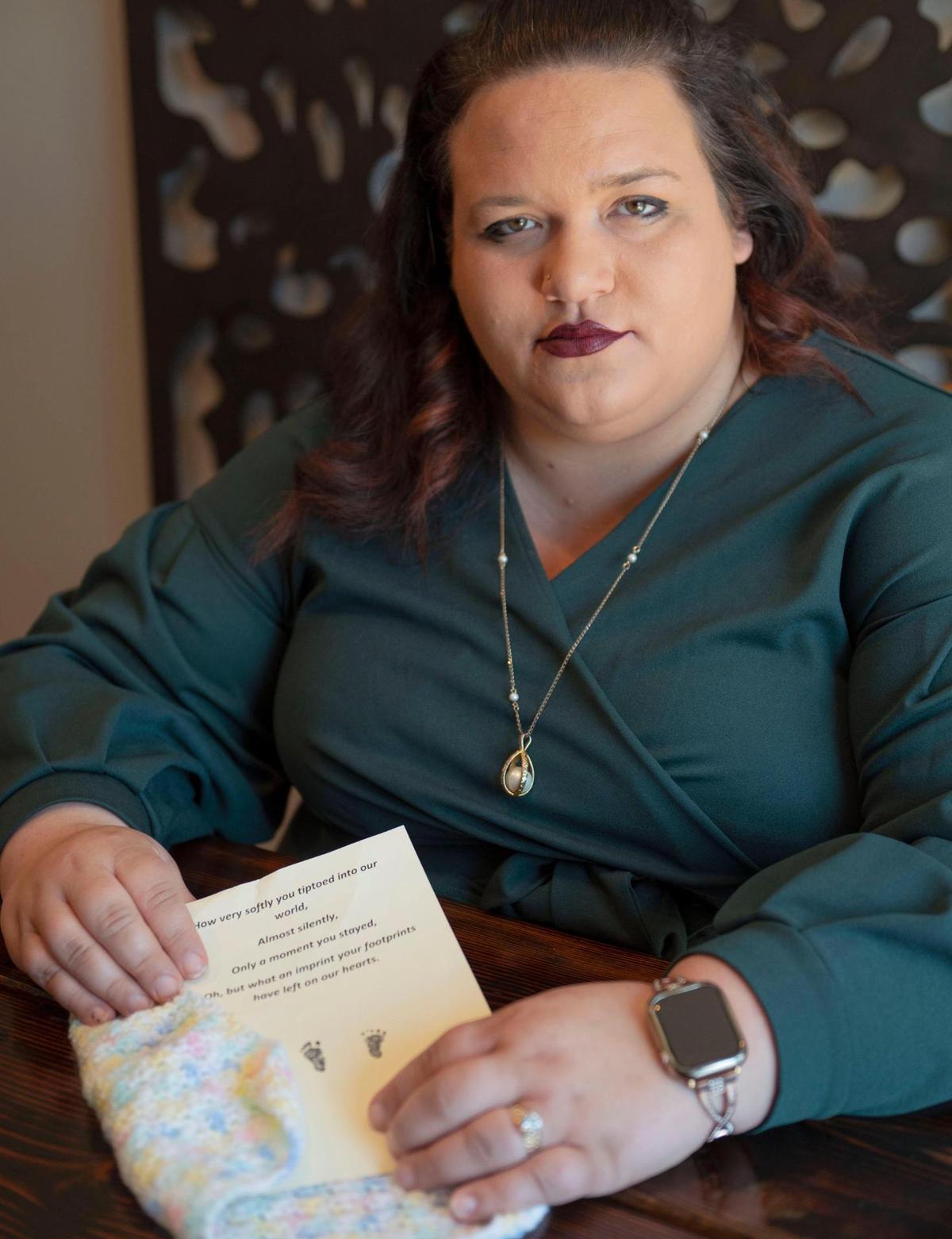 Kelsey Walker, on Wednesday, June 29, 2022, at her home in Raymore, shows a blanket and a poem with her daughter Hope’s footprints that volunteers at a clinic had made for her when she obtained an abortion at 18 weeks pregnant. In 2017 her baby was diagnosed with fetal brittle bone disease, the infant would not have survived and Walker’s life would have been at risk when giving birth.