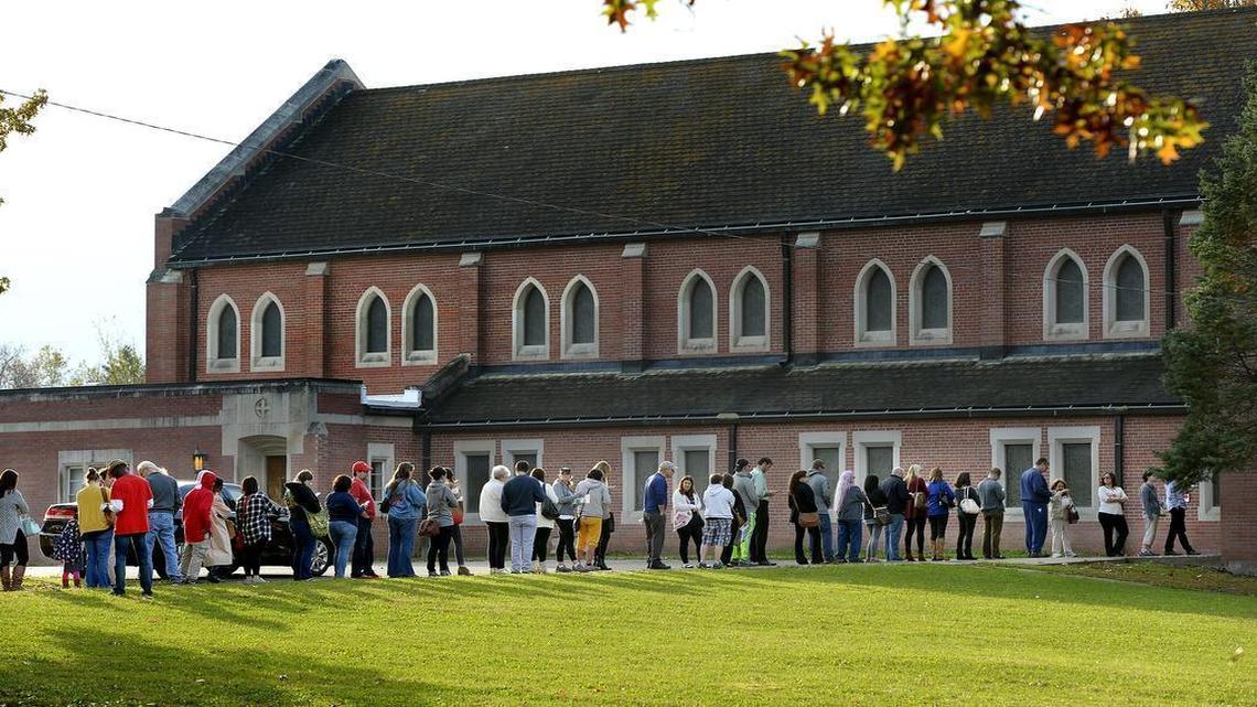 Voters line up outside the South-Broadland Presbyterian Church to vote early in the 2016 presidential election.