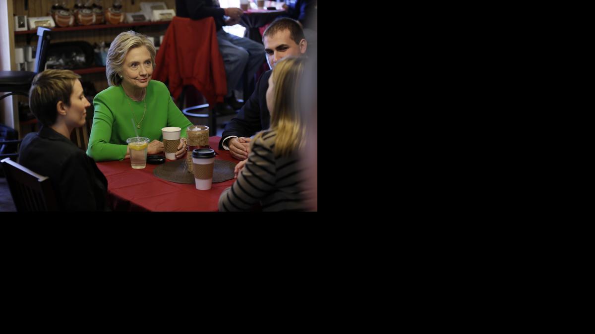 
Democratic presidential candidate Hillary Rodham Clinton meets with customers at the Jones St. Java House Tuesday in LeClaire, Iowa. 
