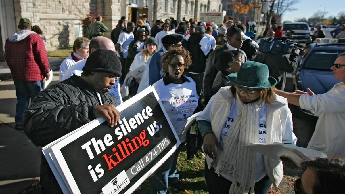 In this 2005 file photo, volunteers for the Jackson County COMBAT anti-violence campaign lined up to pick up signs outside the Metropolitan Missionary Baptist Church at 2310 Linwood Blvd. before standing at intersections on Prospect Avenue with signs asking drivers to report criminal activity to police. First passed in 1989, the anti-drug and violence prevention COMBAT sales tax ON Tuesday was extended for another nine years.