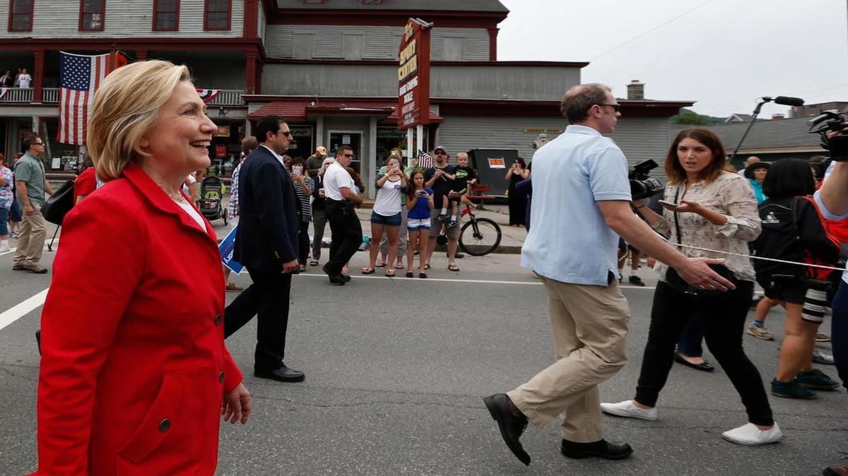 
Members of the media are kept behind a moving rope line as Democratic presidential candidate Hillary Rodham Clinton marches in a Fourth of July parade Saturday
