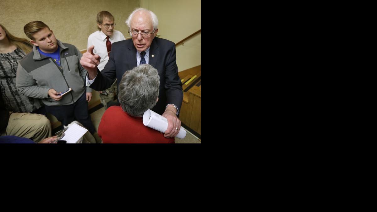 
Sen. Bernie Sanders, I-Vt., right, talks with local residents during a town hall meeting in Ames, Iowa.
