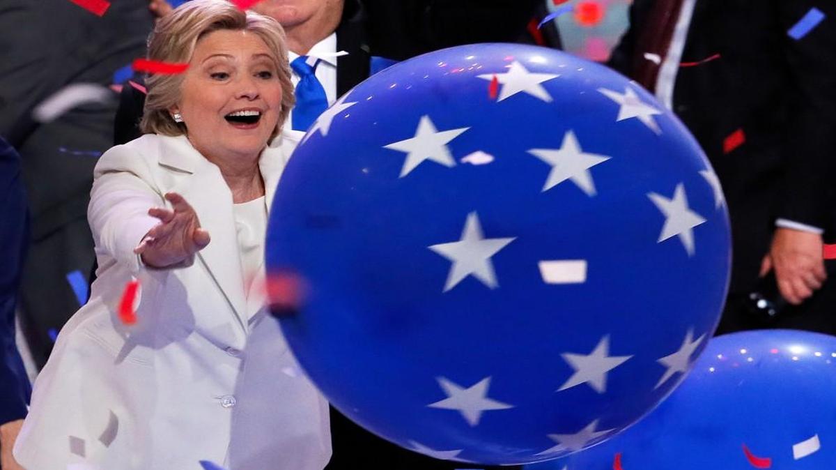 Democratic presidential nominee Hillary Clinton reaches for a falling balloon at the conclusion of the Democratic National Convention in Philadelphia on Thursday.