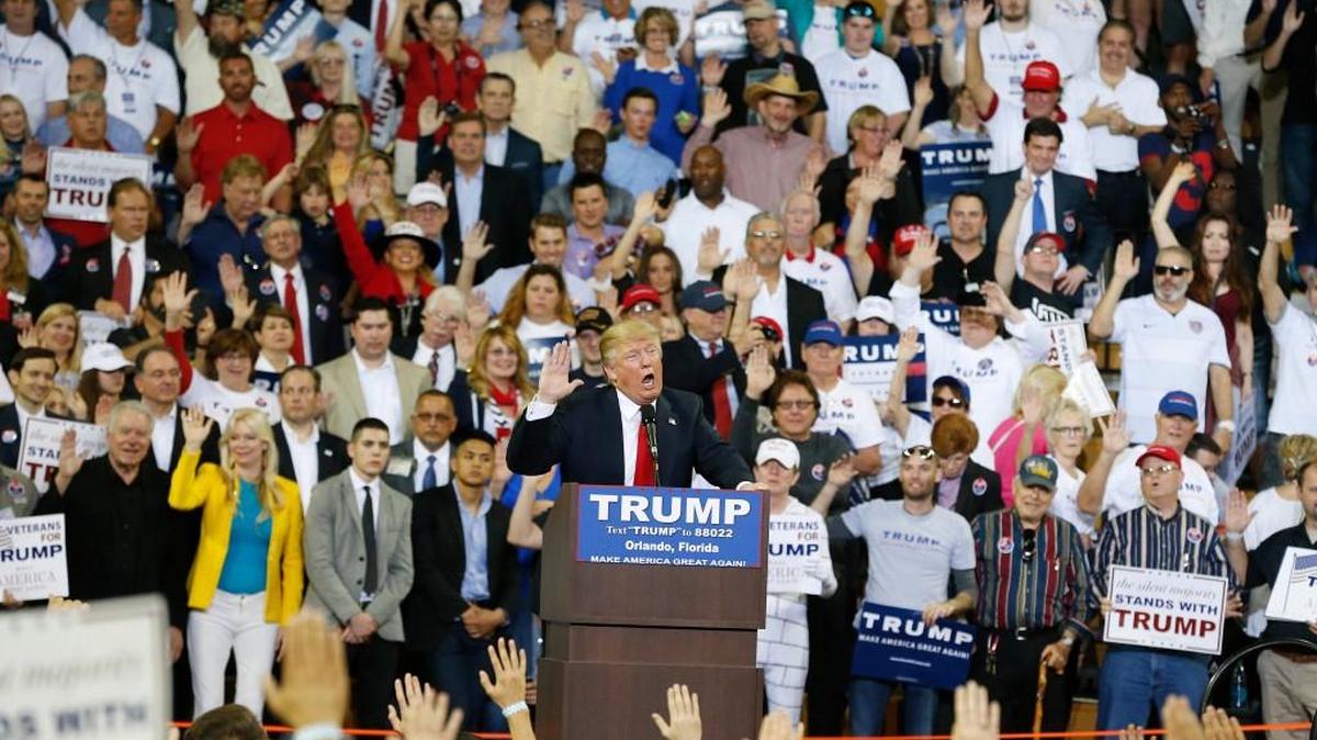 Republican presidential candidate Donald Trump tells the crowd to pledge to promise to vote for him during a campaign rally, in Orlando, Fla.