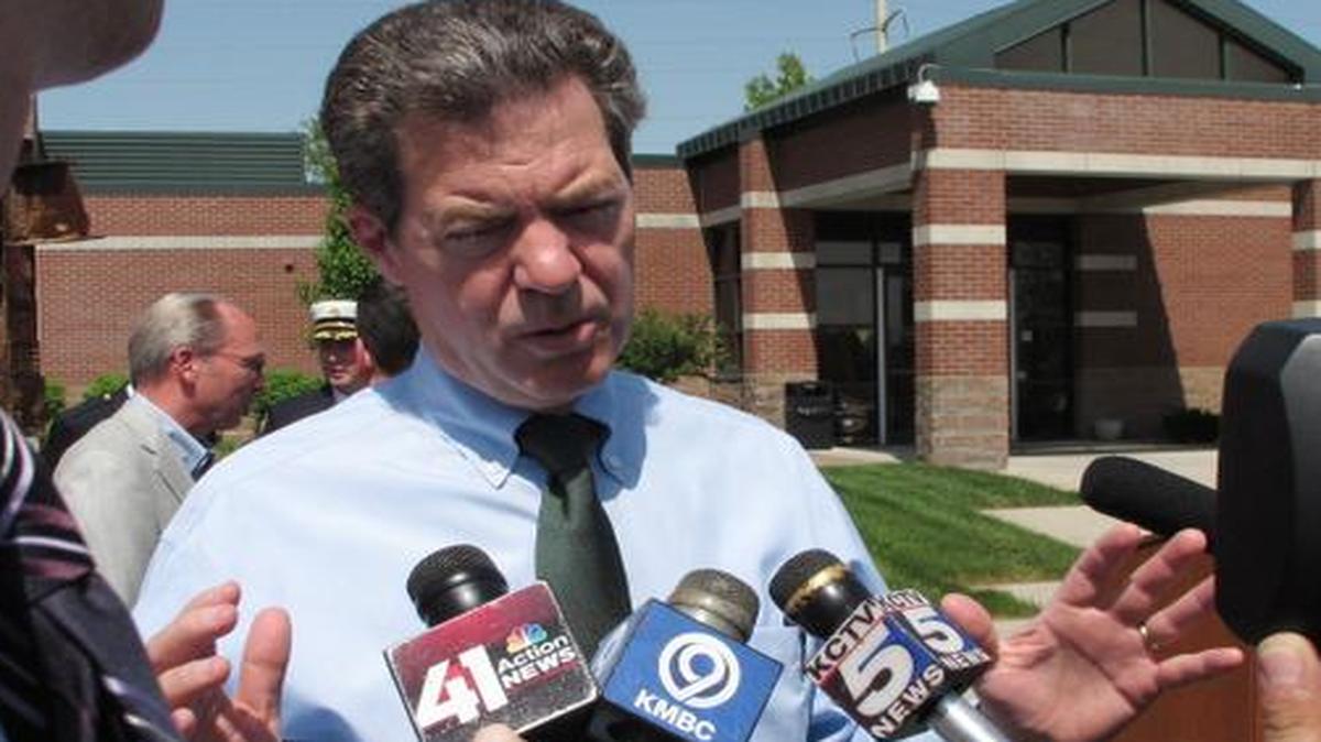 
Republican Gov. Sam Brownback answers questions following an event in Overland Park. 
